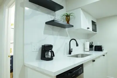 a white kitchen with a sink and a counter top at Spacious 2-Bed-Room near Yonge & Major Mackenzie in Richmond Hill