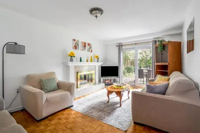 a living room with a couch and a fireplace at Glengarry Haus Spacious 2BR Home Away From Home in Mississauga