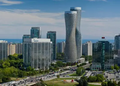 a view of a city with a tall building at Glengarry Haus Spacious 2BR Home Away From Home in Mississauga