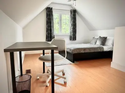 a bedroom with a bed and a desk and a table at Cottage Retreat on 11 Acres in Flesherton