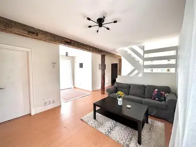 a living room with a couch and a table at Cottage Retreat on 11 Acres in Flesherton