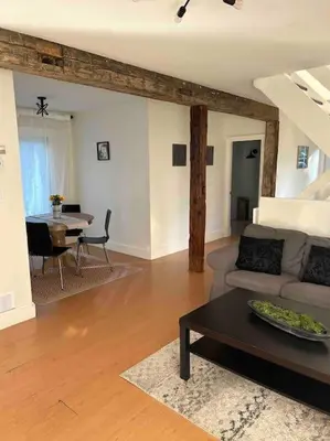 a living room with a couch and a table at Cottage Retreat on 11 Acres in Flesherton