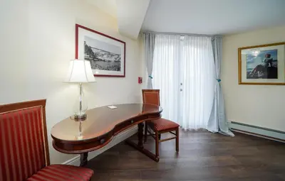 a room with a desk and a chair and a lamp at Niagara Grandview Boutique Hotel in Niagara Falls