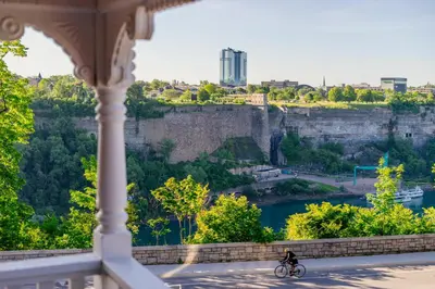 a person riding a bike on a bridge over a river at Niagara Grandview Boutique Hotel in Niagara Falls