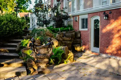 a garden in front of a brick building at Niagara Grandview Boutique Hotel in Niagara Falls