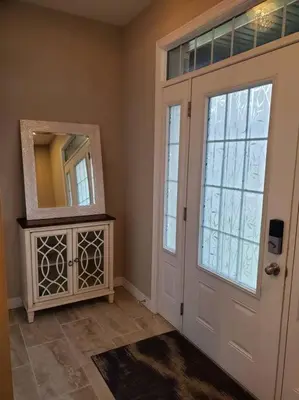 a room with a door and a mirror next to a door at 4 BD Family Retreat - Basement not Included in Stratford