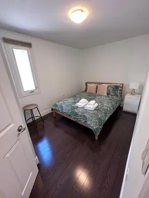 a bedroom with a bed in a room with a window at Toronto GREAT Located in Toronto