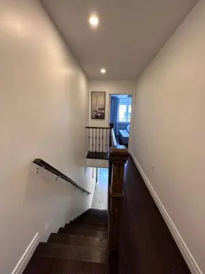 a staircase in a home with white walls and wood floors at Toronto GREAT Located in Toronto