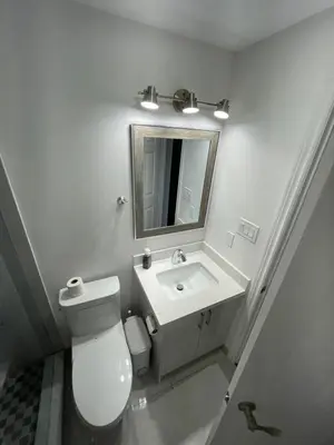 a bathroom with a toilet and a sink and a mirror at Toronto GREAT Located in Toronto