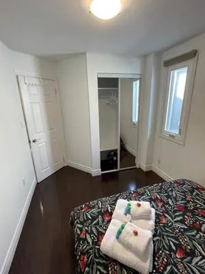 a bedroom with a bed with two towels on it at Toronto GREAT Located in Toronto