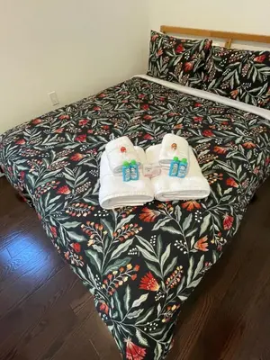 a bedroom with a bed with towels on it at Toronto GREAT Located in Toronto