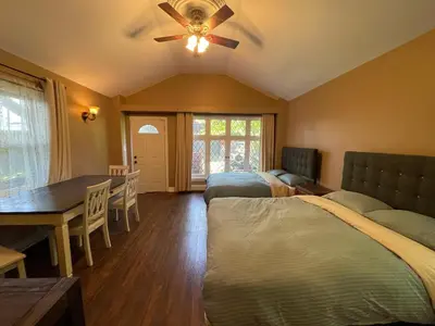 a bedroom with two beds and a table and a dining room at THE RED STAR room E in Niagara Falls