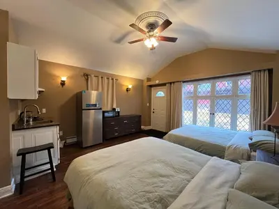 a bedroom with two beds and a ceiling fan at THE RED STAR room E in Niagara Falls