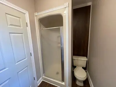 a bathroom with a toilet and a walk in shower at THE RED STAR room E in Niagara Falls