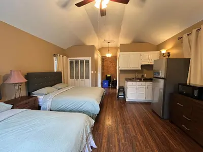 a bedroom with two beds and a kitchen at THE RED STAR room E in Niagara Falls