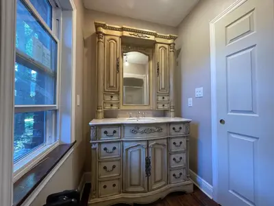 a bathroom with a wooden dresser with a mirror at THE RED STAR room E in Niagara Falls