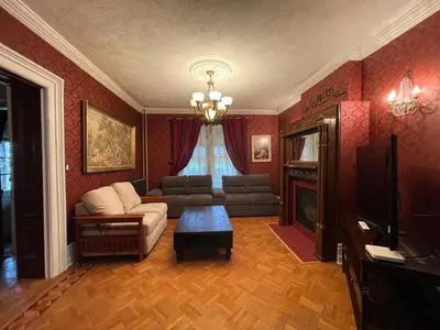 a living room with a couch and a table at THE RED STAR ROOM B in Niagara Falls