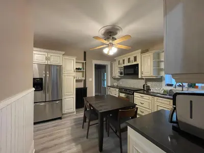a kitchen with a table and a ceiling fan at THE RED STAR ROOM B in Niagara Falls