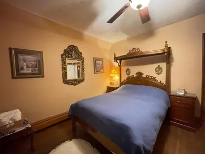 a bedroom with a bed and a ceiling fan at THE RED STAR ROOM B in Niagara Falls