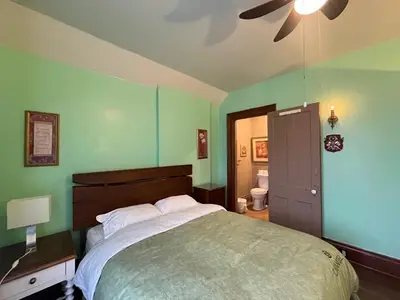 a bedroom with a large bed and a ceiling fan at THE RED STAR ROOM A in Niagara Falls