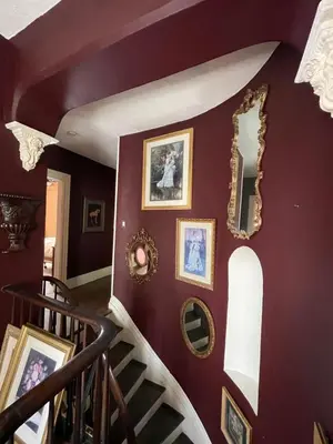 a staircase in a house with pictures on the wall at THE RED STAR ROOM A in Niagara Falls