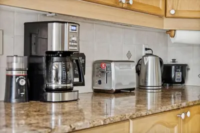 a kitchen counter with various appliances on a counter top at The cozy corner House in the Richmond Hill in Richmond Hill