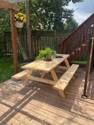 a wooden picnic table and bench on a deck at The cozy corner House in the Richmond Hill in Richmond Hill