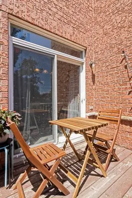 a wooden picnic table and two chairs on a patio at The cozy corner House in the Richmond Hill in Richmond Hill