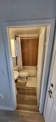 a small bathroom with a toilet and a sink at Happyland Inn in Orillia