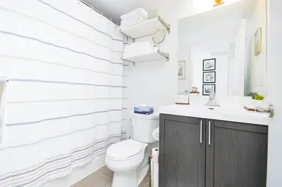 a bathroom with a toilet and a sink at The Splendid - Luxury 1BR Uptown Toronto in Toronto