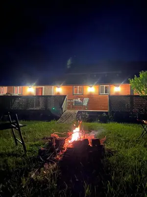 a campfire in front of a house at night at Cottage in Crystal Beach in Fort Erie