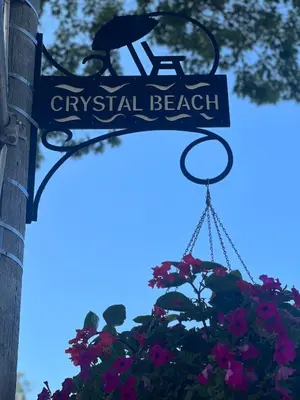 a street sign for a tropical beach with flowers at Cottage in Crystal Beach in Fort Erie