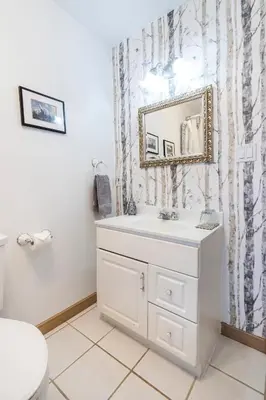 a bathroom with a white sink and a mirror at The Inn on Bay in Gravenhurst