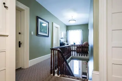 a hallway with a spiral staircase in a home at The Inn on Bay in Gravenhurst