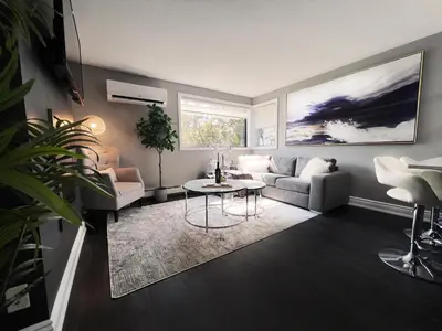 a living room with a couch and a table at *NEW* Elegant Urban 2BR Retreat in London