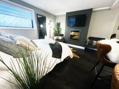 a bedroom with a bed and a tv and a couch at Stylish Boutique Studio in London