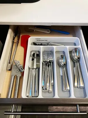 a tray of silver utensils in a drawer at Stylish Boutique Studio in London