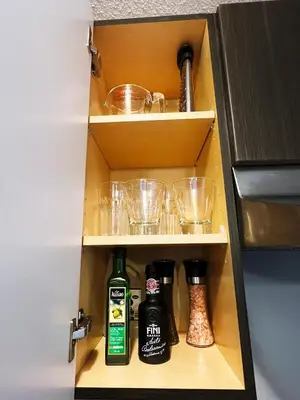 a cupboard with alcohol bottles and glasses in it at Stylish Boutique Studio in London