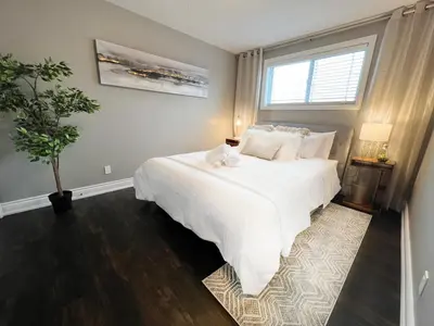 a bedroom with a large white bed and a window at The Capri Suite in Old South London in London