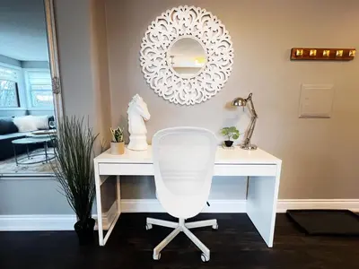 a white desk with a chair and a mirror at The Capri Suite in Old South London in London