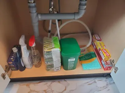 a shelf under a sink with hygiene items on it at The Cosmopolitan in Wortley Village in London