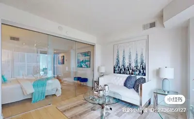 a living room with a white couch and a glass table at University of Toronto UTSG Suites in Toronto