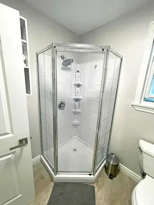 a glass shower in a bathroom with a toilet at Hamilton Haven - Smart Tech and BBQ Oasis - Pool in Hamilton