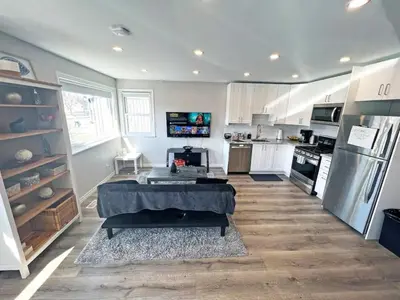 a kitchen with a table in the middle of a room at Hamilton Haven - Smart Tech and BBQ Oasis - Pool in Hamilton