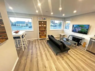 a living room with a couch and a table at Hamilton Haven - Smart Tech and BBQ Oasis - Pool in Hamilton