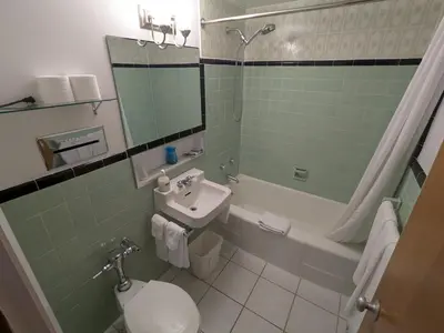 a bathroom with a sink and a toilet and a shower at Mariner motor hotel in Collingwood