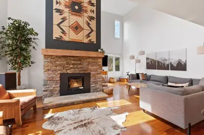 a living room with a couch and a fireplace at Luxury 2 Level Mountain Walk Condo Sauna Jacuzzi Walk to Village in Blue Mountains