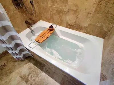 a bath tub filled with water with a toy in it at Luxury 2 Level Mountain Walk Condo Sauna Jacuzzi Walk to Village in Blue Mountains
