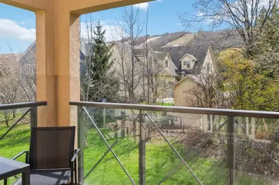 a balcony with a view of a house at Luxury 2 Level Mountain Walk Condo Sauna Jacuzzi Walk to Village in Blue Mountains