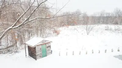 a out house in the snow with a fence at Blue Mountain 6BR Chalet Modern Hot Tub Mountain Views Walk to Village in Blue Mountains